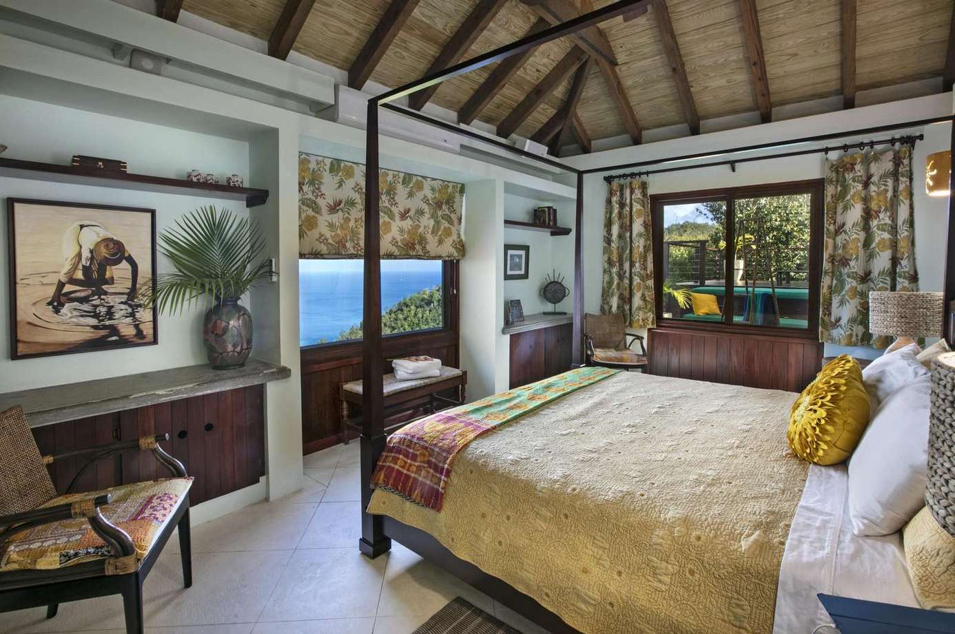 Spacious bedroom with vaulted ceiling and ocean views