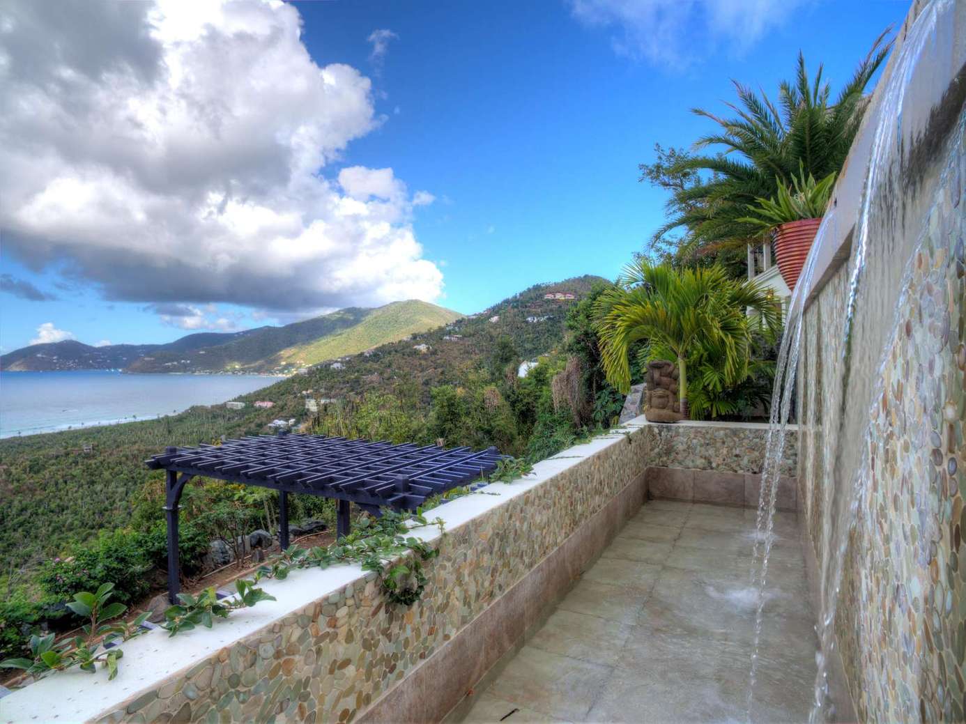 Outdoor shower with stunning ocean and mountain views
