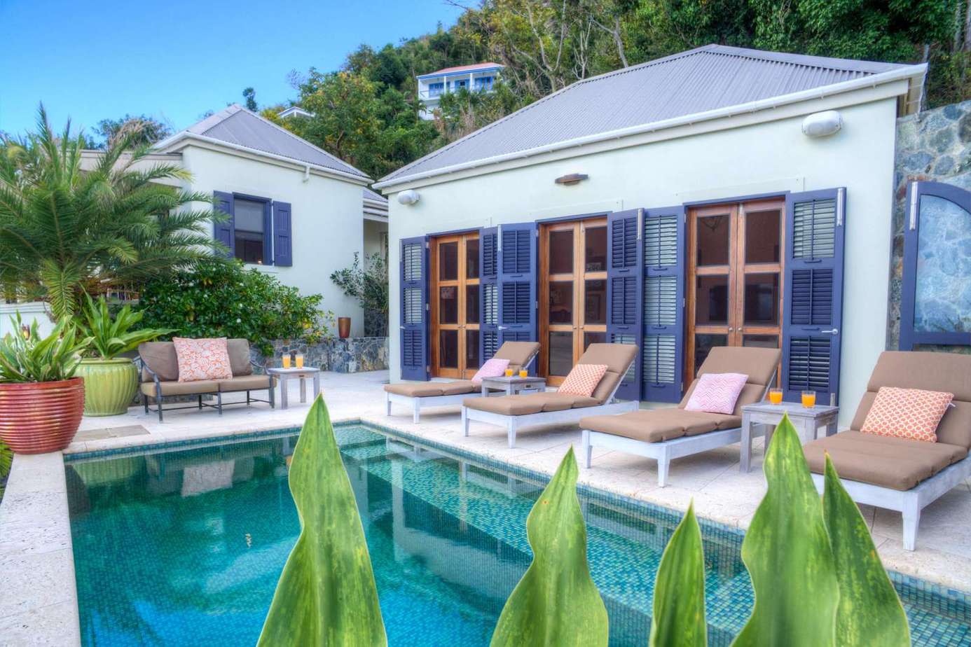 Sunlit poolside patio with cozy lounge seating