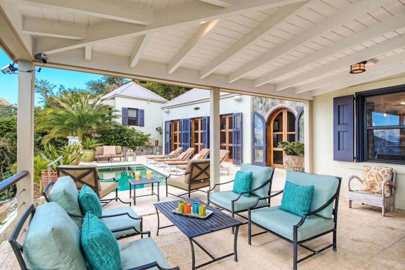 Shaded patio oasis with cozy seating and pool views