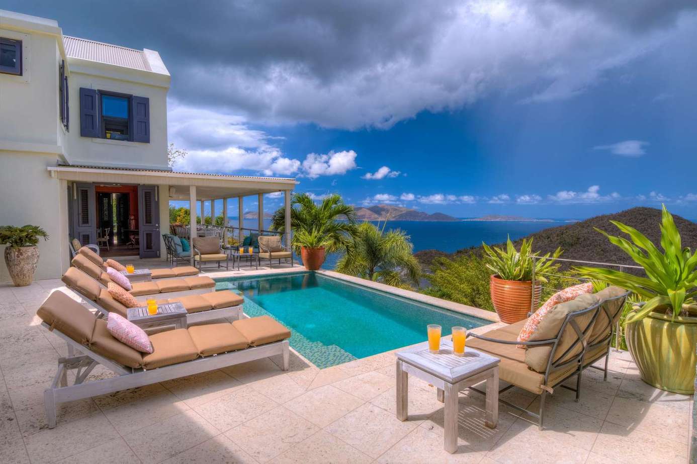 Sun-soaked patio with pool and stunning ocean views