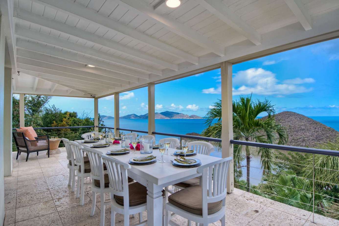 Spacious covered patio with panoramic ocean views and dining area