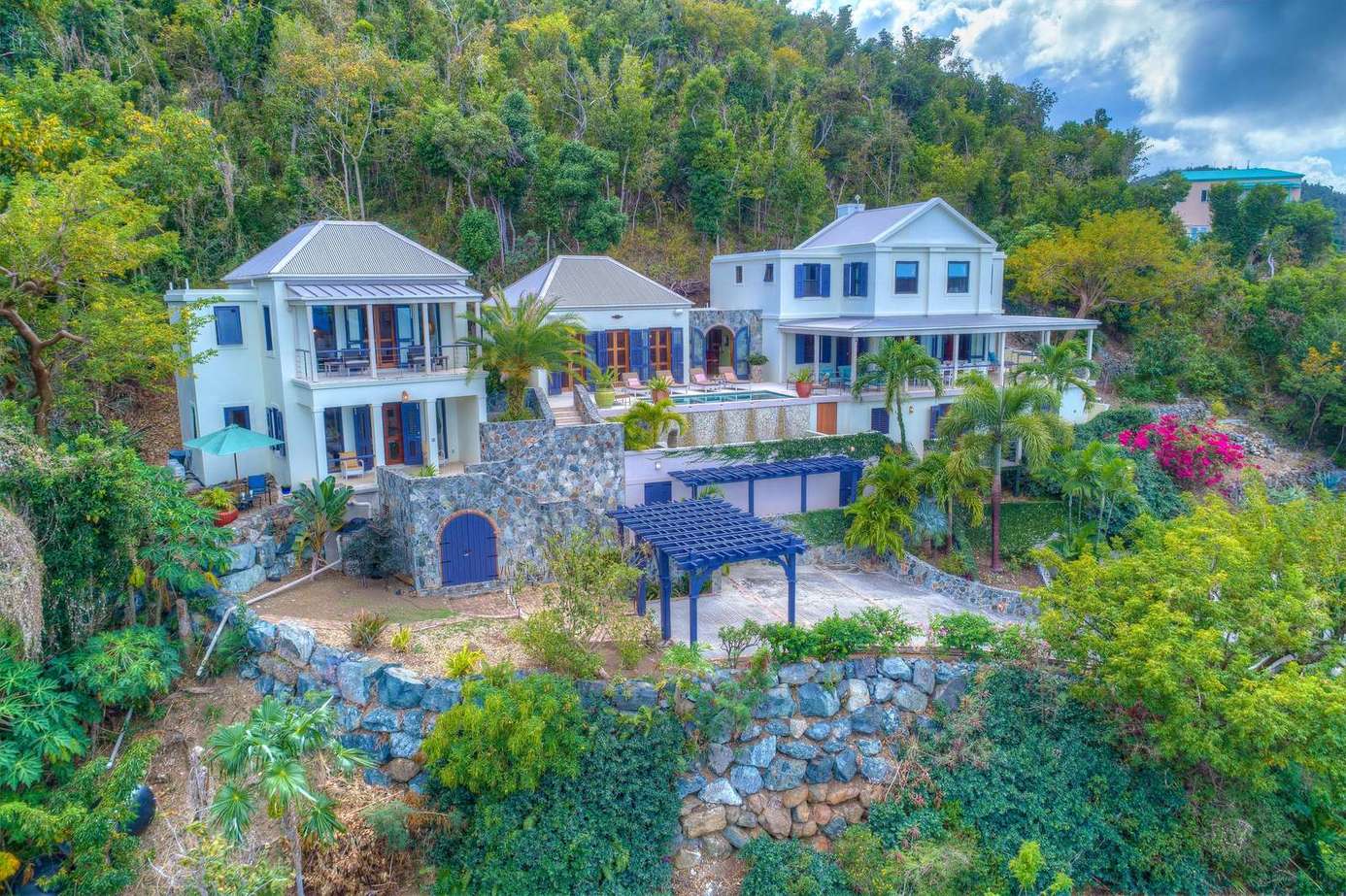 Expansive hillside estate with stunning panoramic views and lush gardens