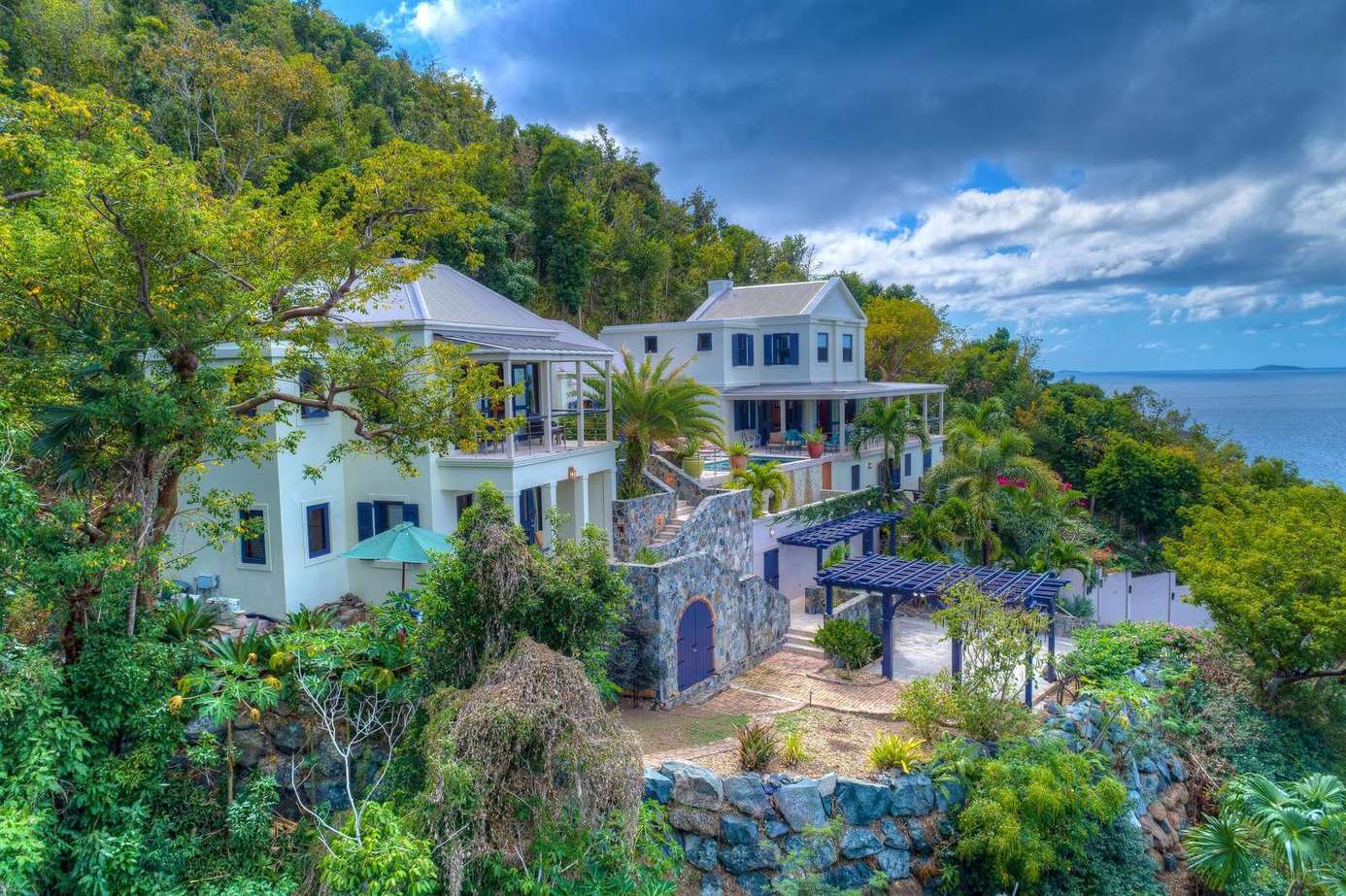 Secluded hillside villa with panoramic ocean views and lush gardens