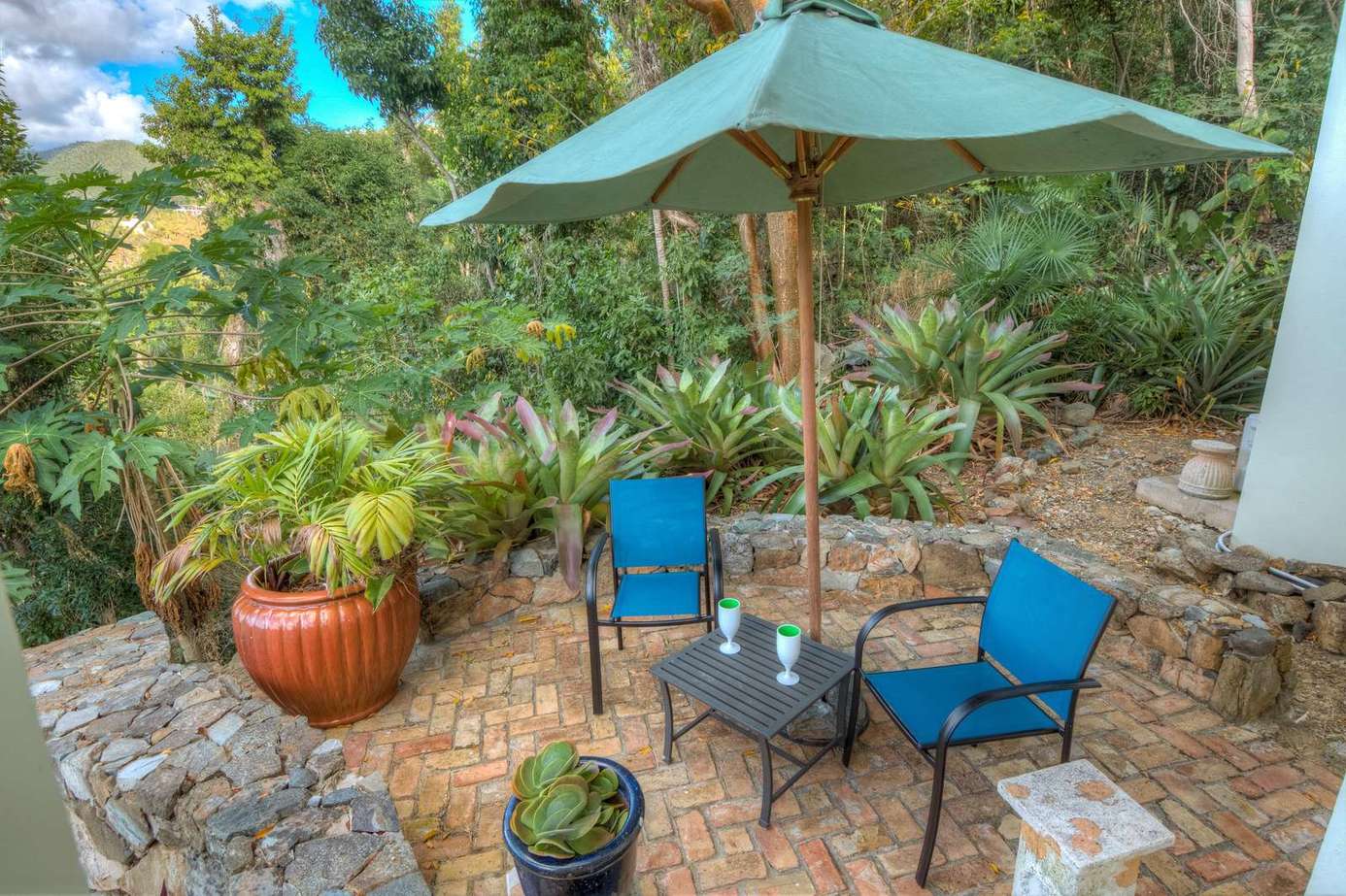 Cozy outdoor patio retreat surrounded by lush greenery