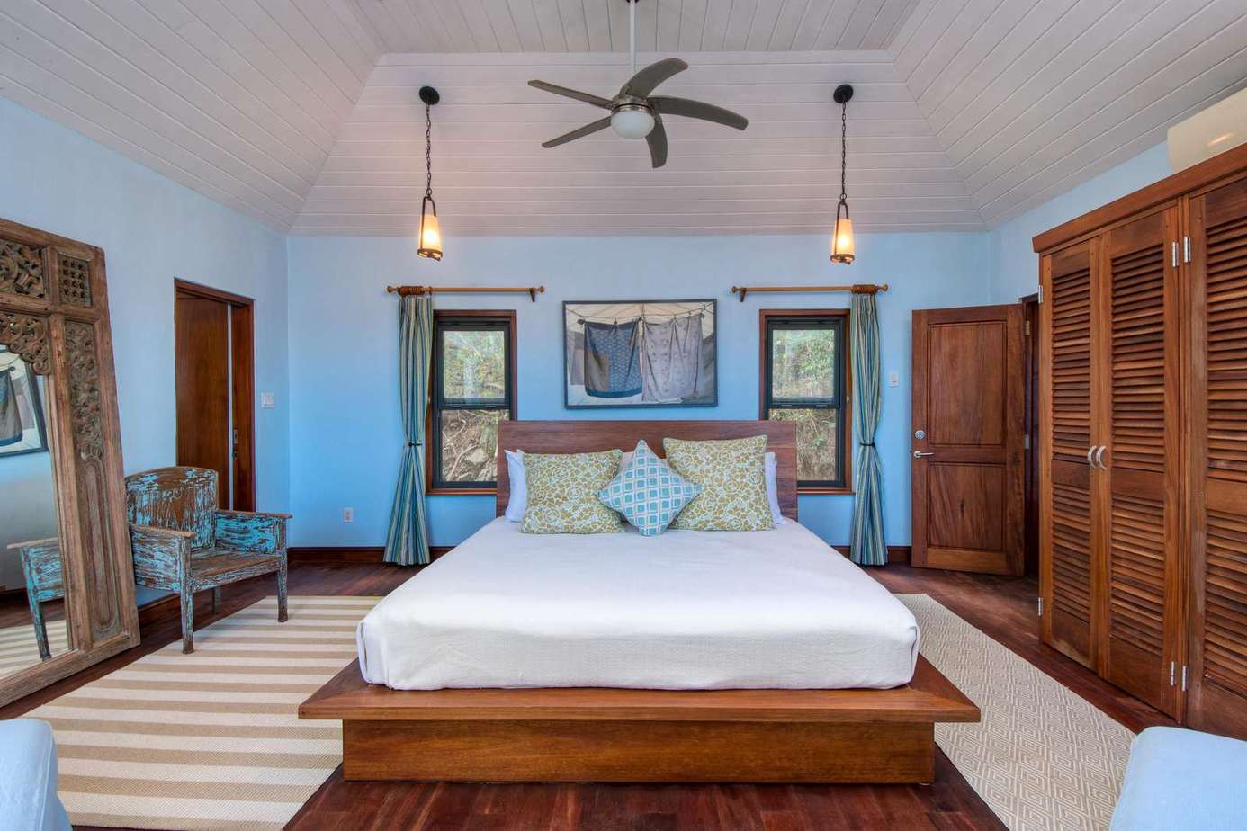 Spacious bedroom with cozy seating and natural light