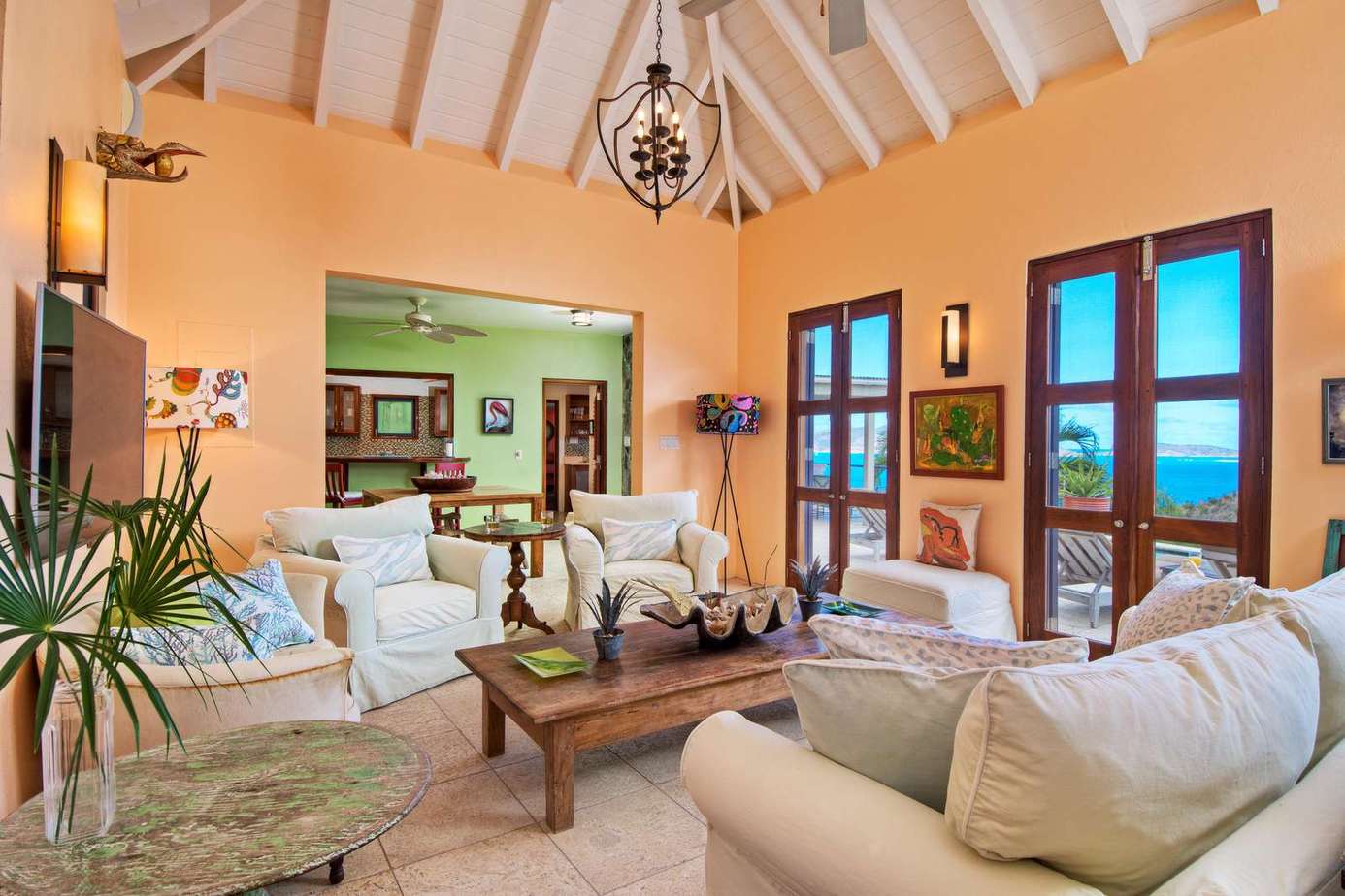 Sunlit living room with vaulted ceilings and ocean views