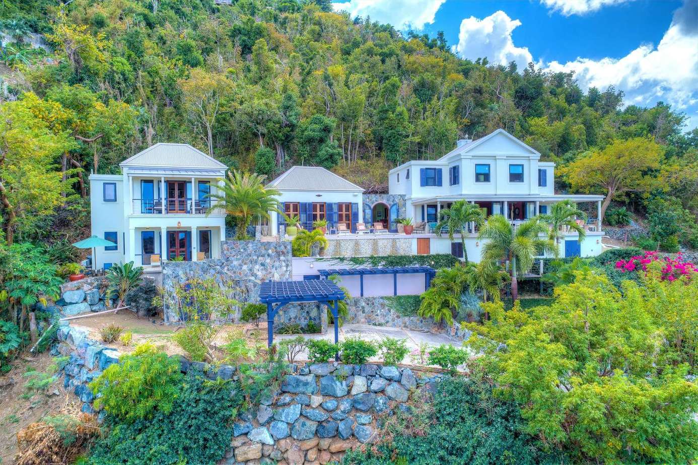 Sprawling hillside villa with panoramic mountain views and lush gardens