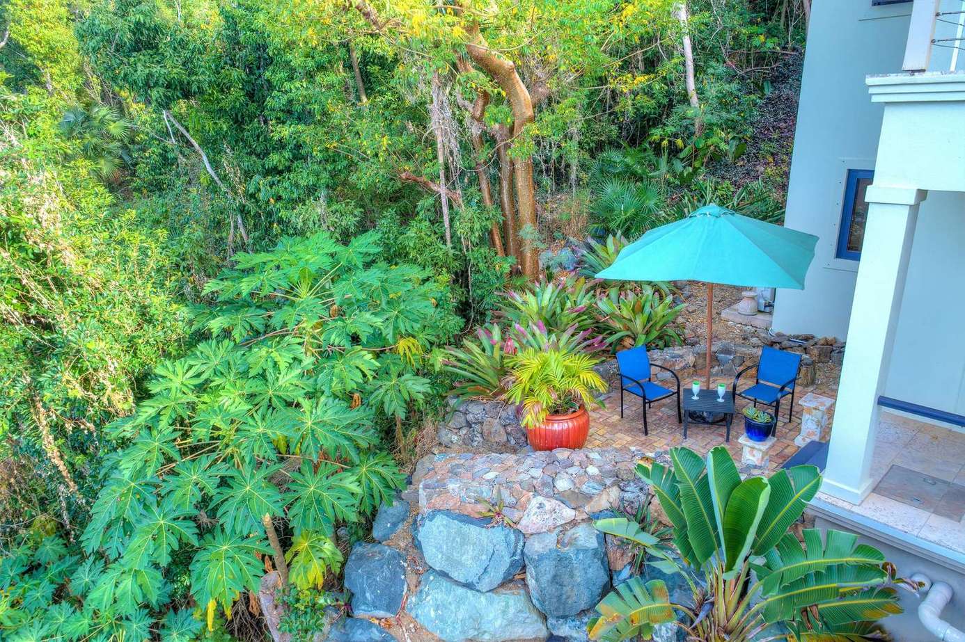 Secluded patio oasis surrounded by lush greenery and stone accents