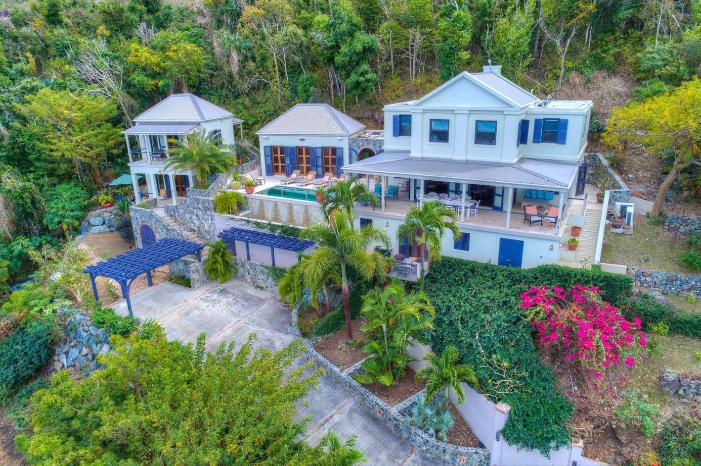 Sprawling hillside retreat with lush gardens and multiple decks