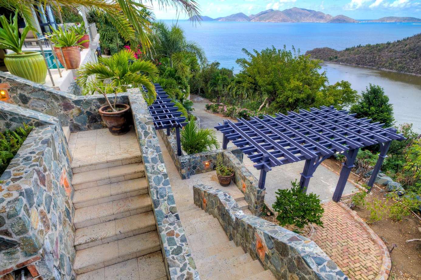 Terrace with panoramic water views and cozy pergola seating