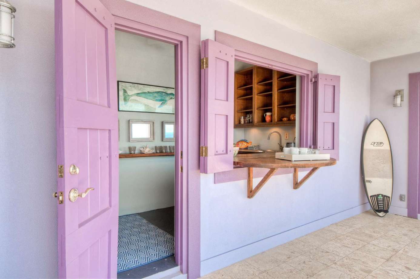 Charming patio with pastel shutters and cozy serving window