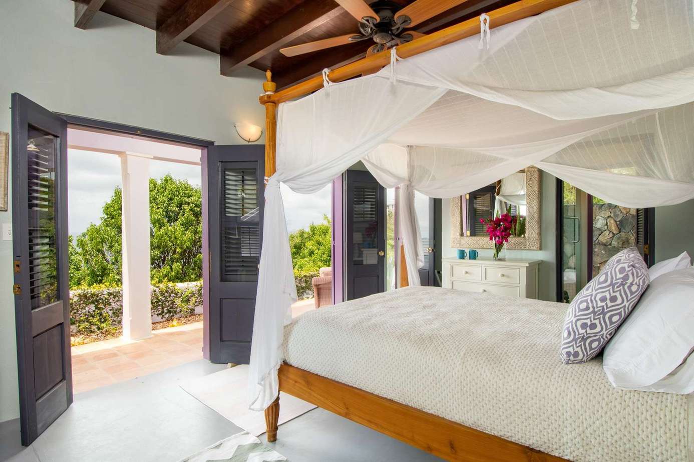 Airy bedroom with rustic beams and garden views