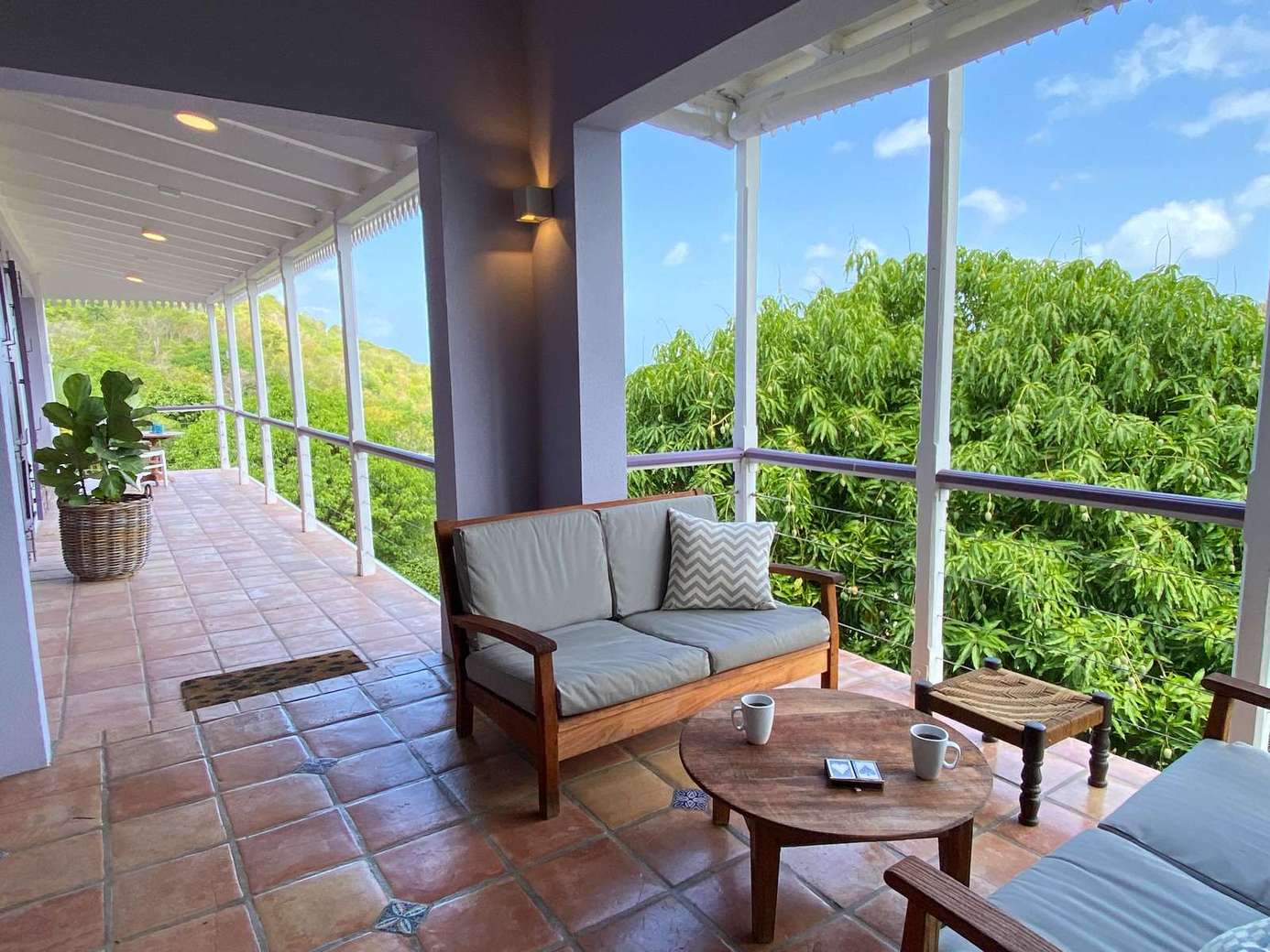 Relax on the spacious screened porch with lush treetop views