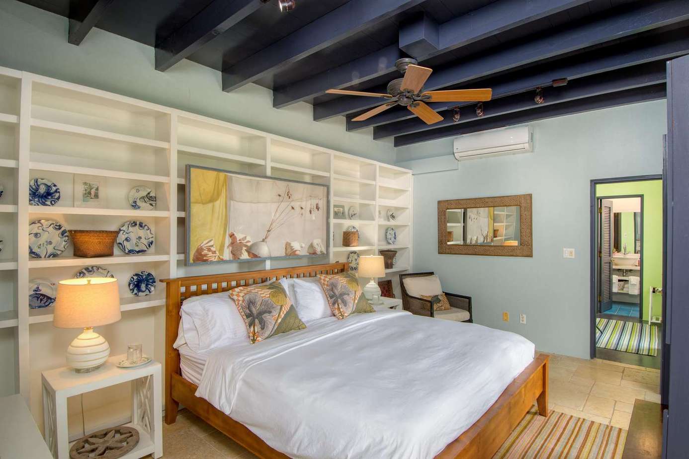 Cozy bedroom with rustic beams and built-in shelves