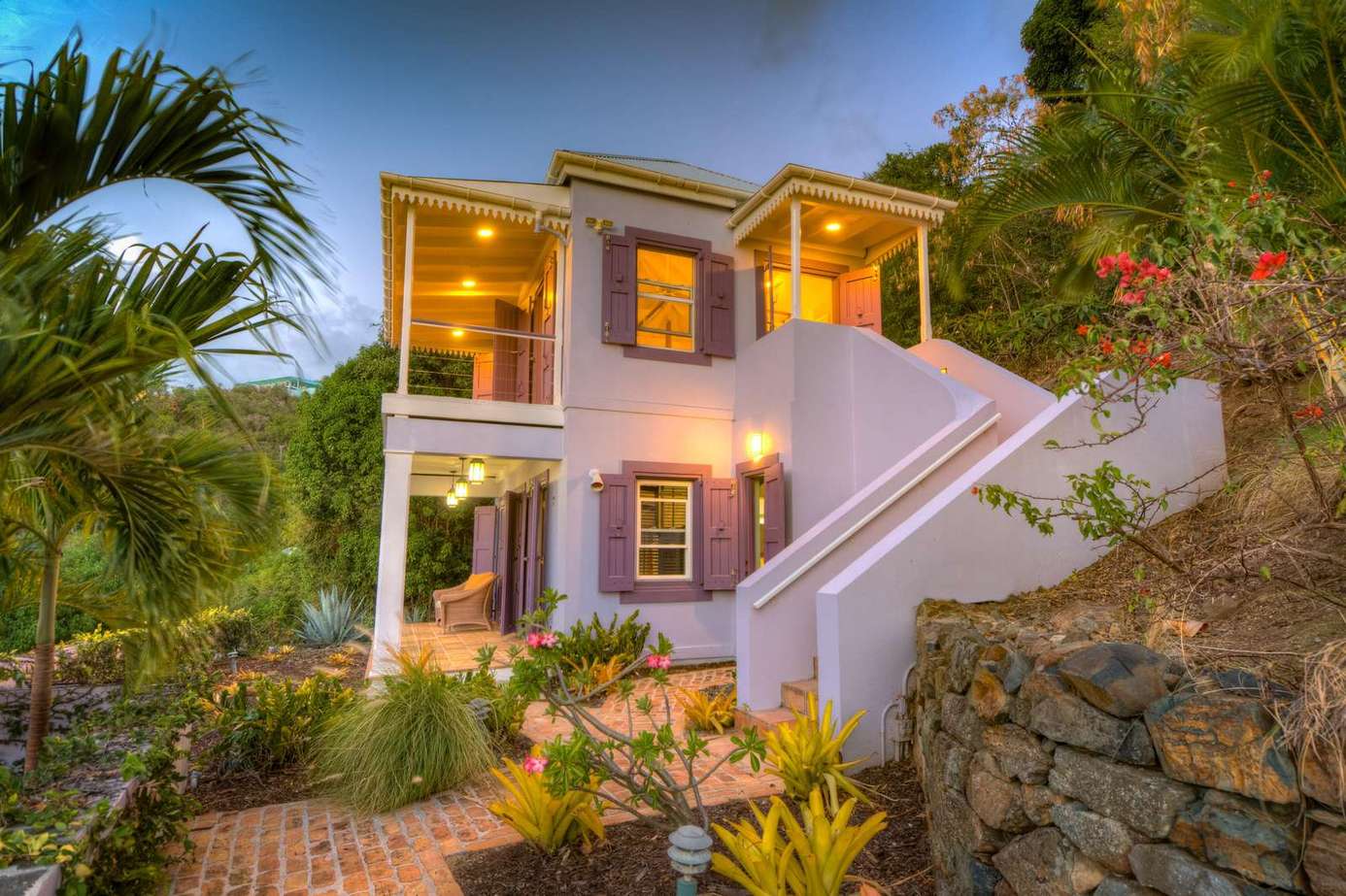 Charming two-story home with lush tropical landscaping