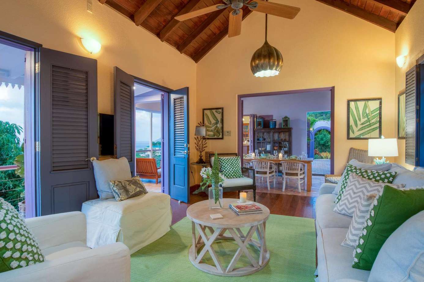Cozy living room with vaulted ceilings and garden views