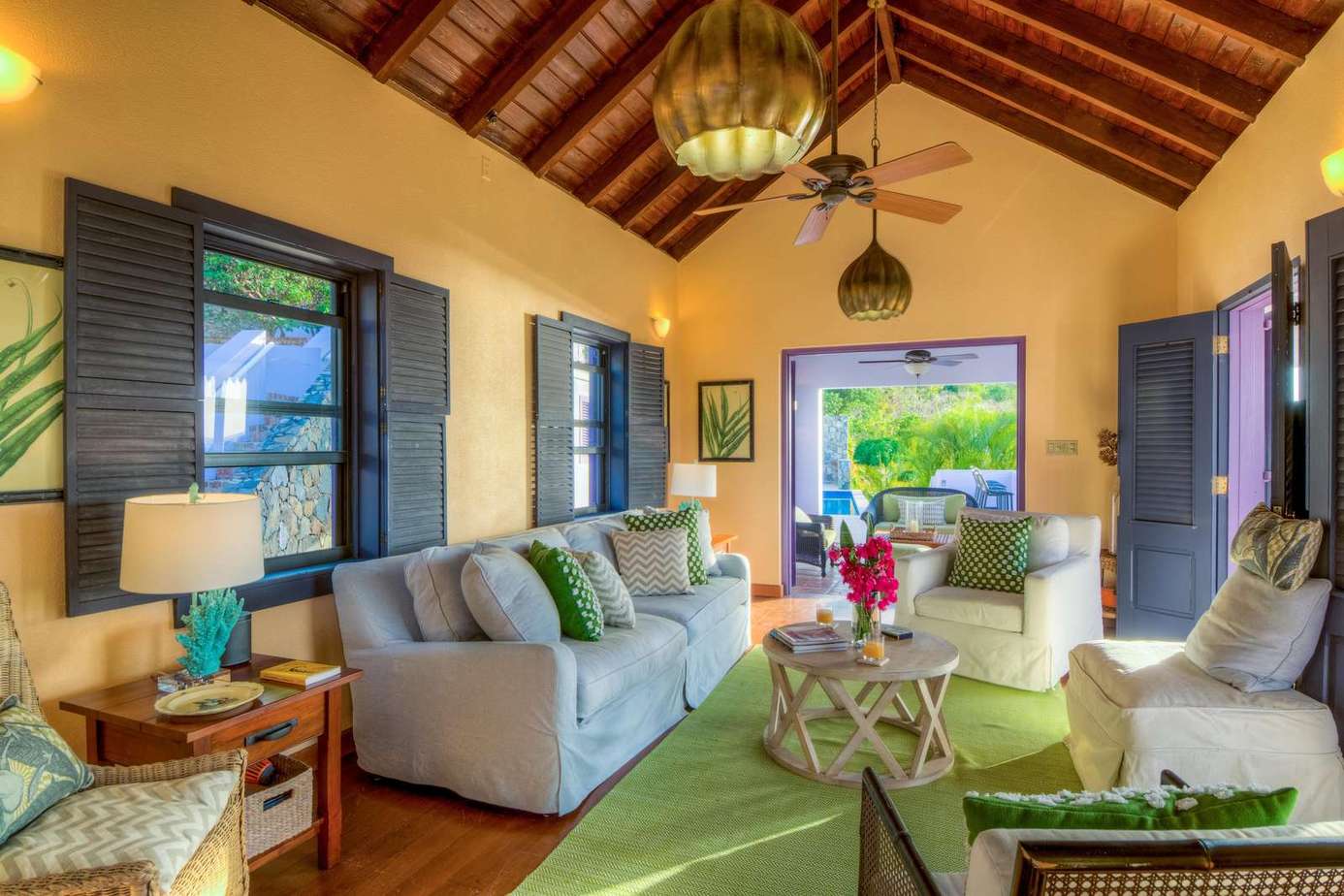 Sunlit living room with vaulted ceilings and garden views