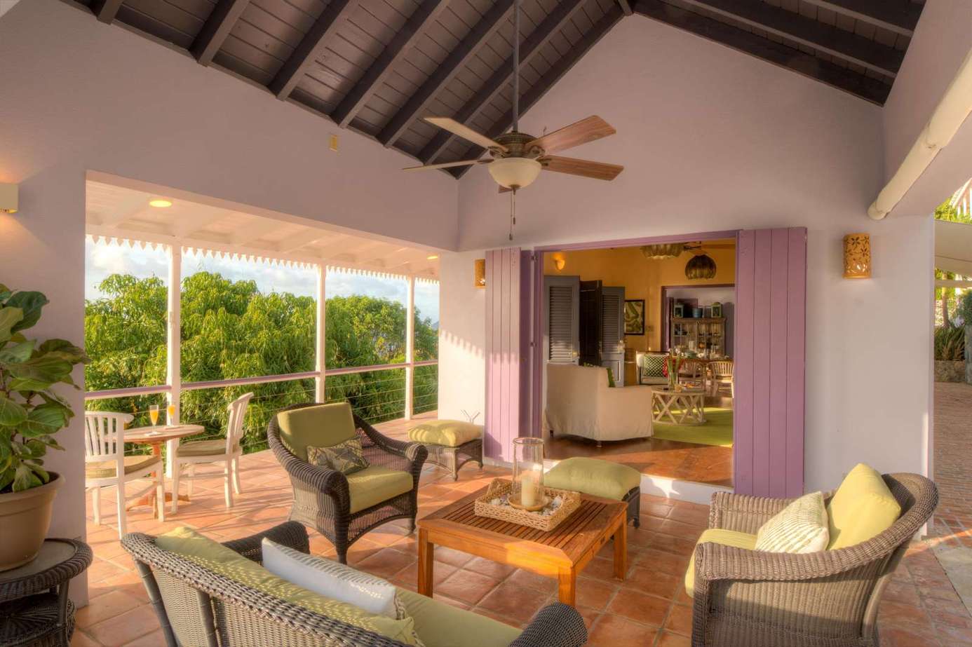 Spacious covered patio with cozy seating and garden views