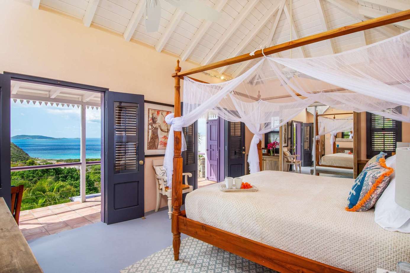 Airy bedroom with canopy bed and stunning ocean views