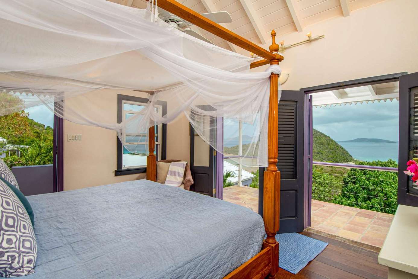 Airy bedroom with canopy bed and ocean views