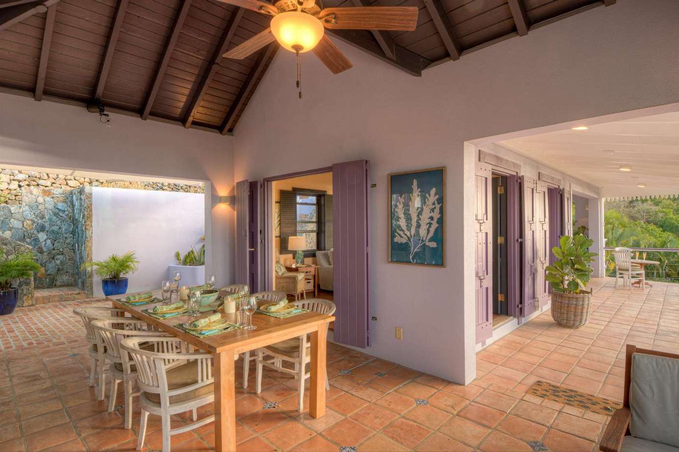 Spacious covered patio with cozy dining and garden views