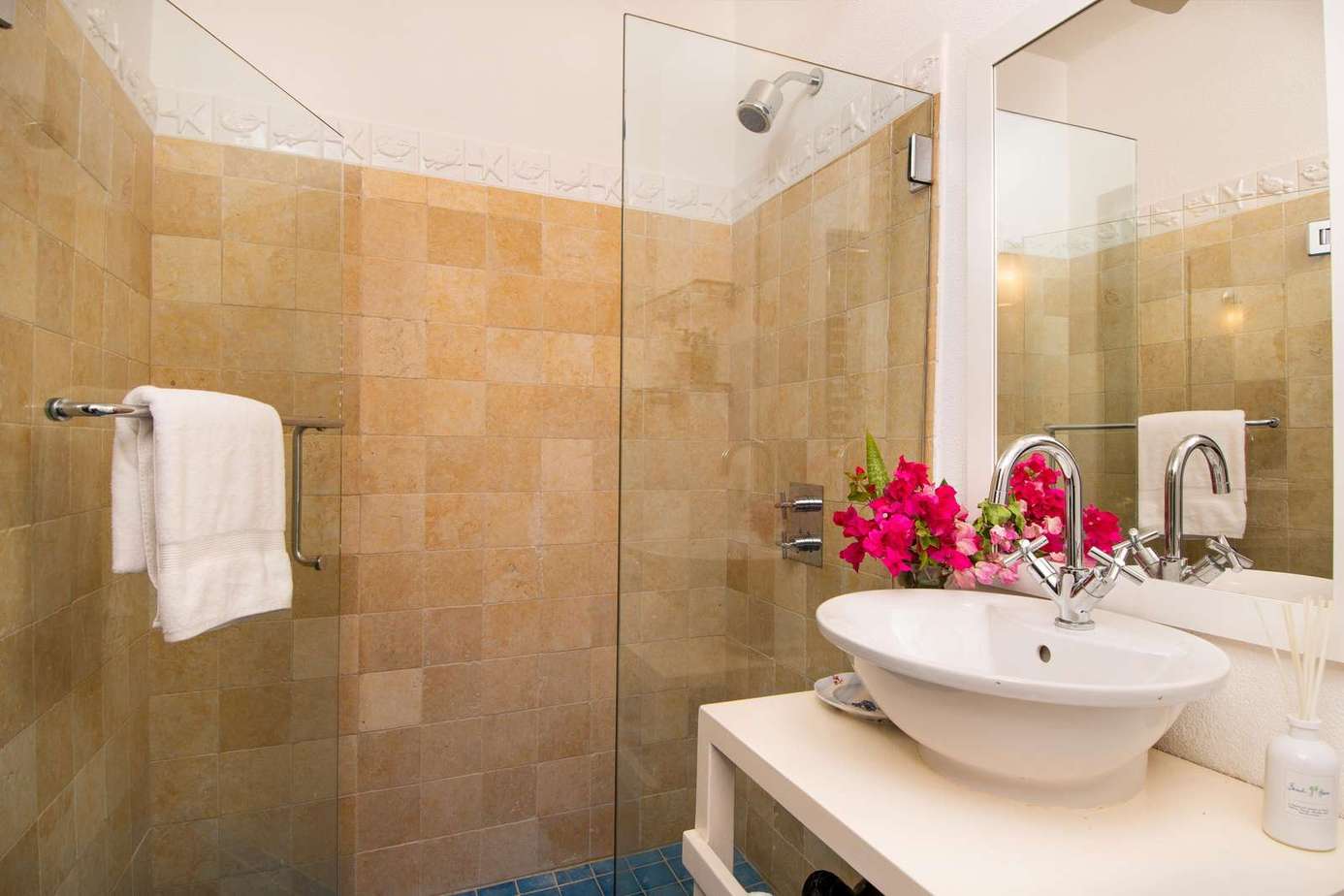 Bright, modern bathroom with spacious glass shower and elegant sink
