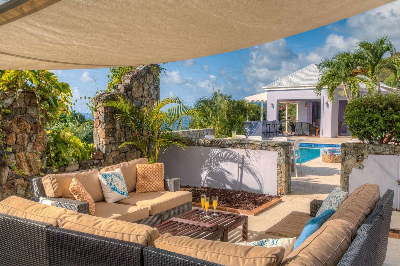 Spacious outdoor lounge with fire pit and poolside views