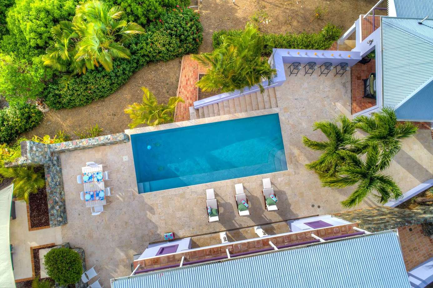 Private pool oasis with loungers and lush greenery