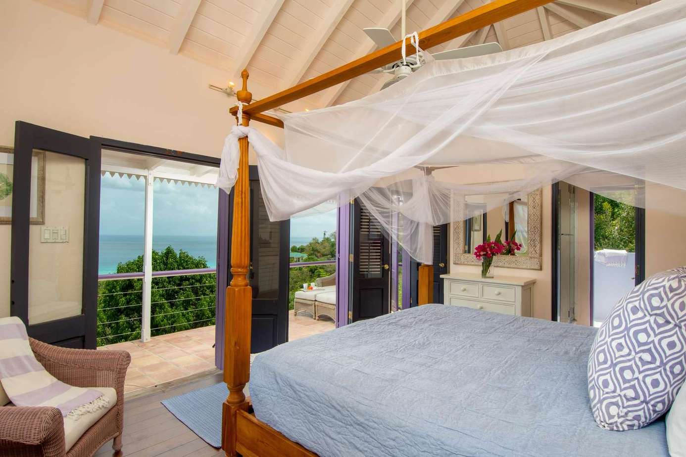 Airy bedroom with canopy bed and stunning ocean views