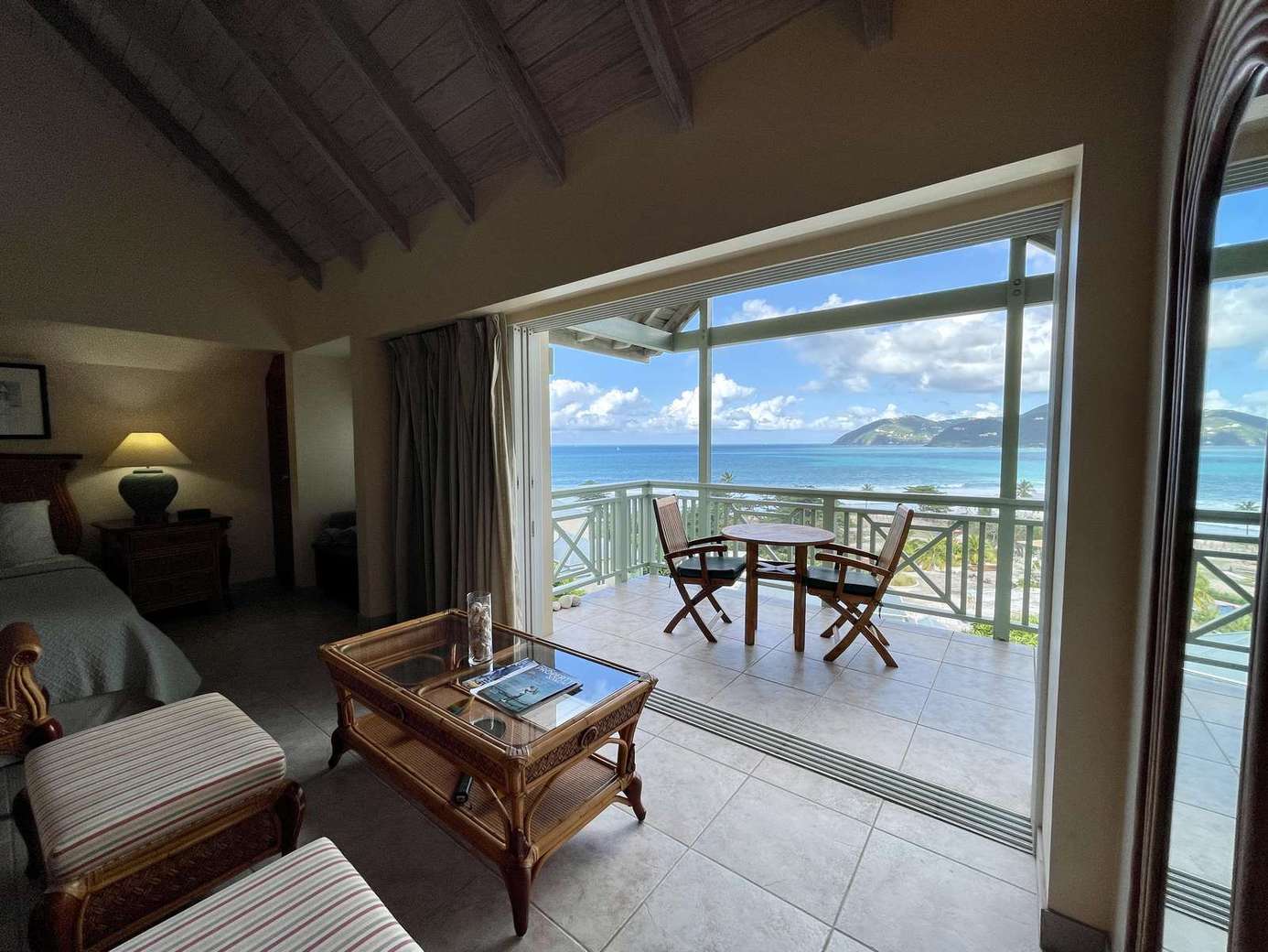 Sunlit living room with stunning ocean view balcony