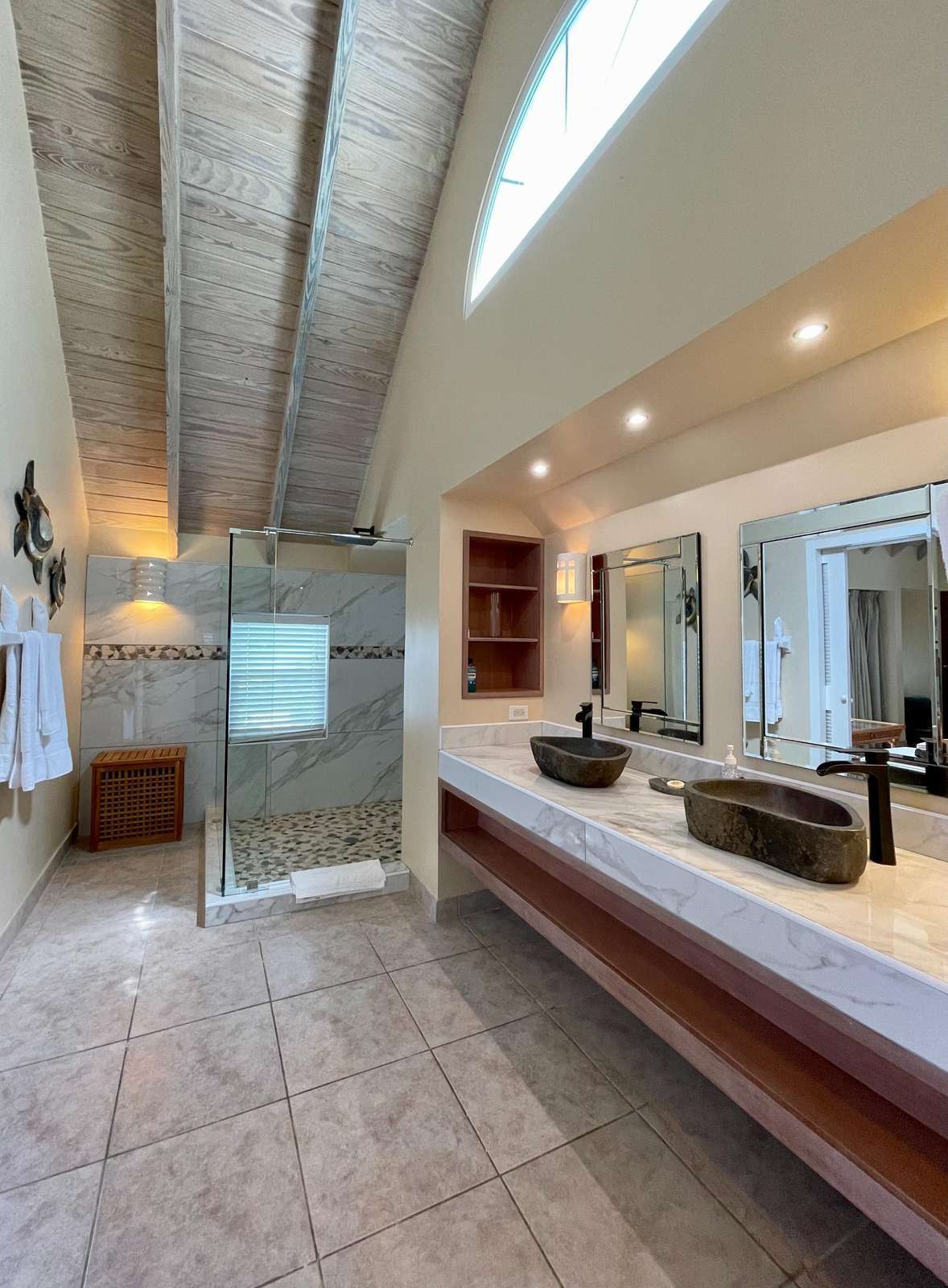 Spacious modern bathroom with skylight and double vanity