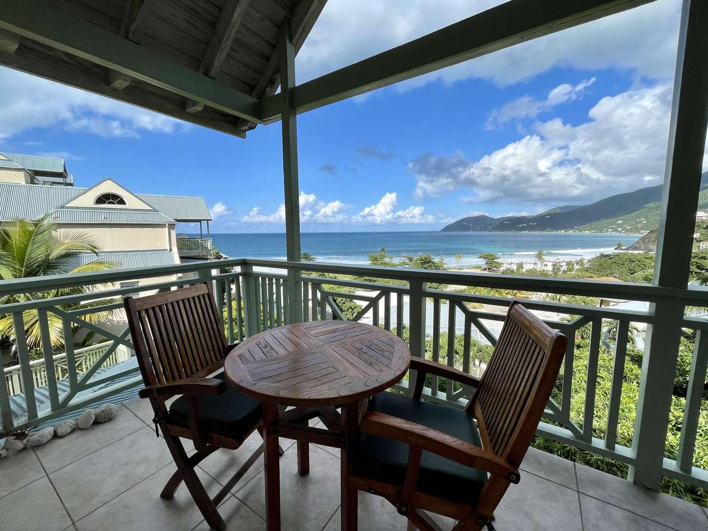 Cozy balcony retreat with stunning ocean and mountain views