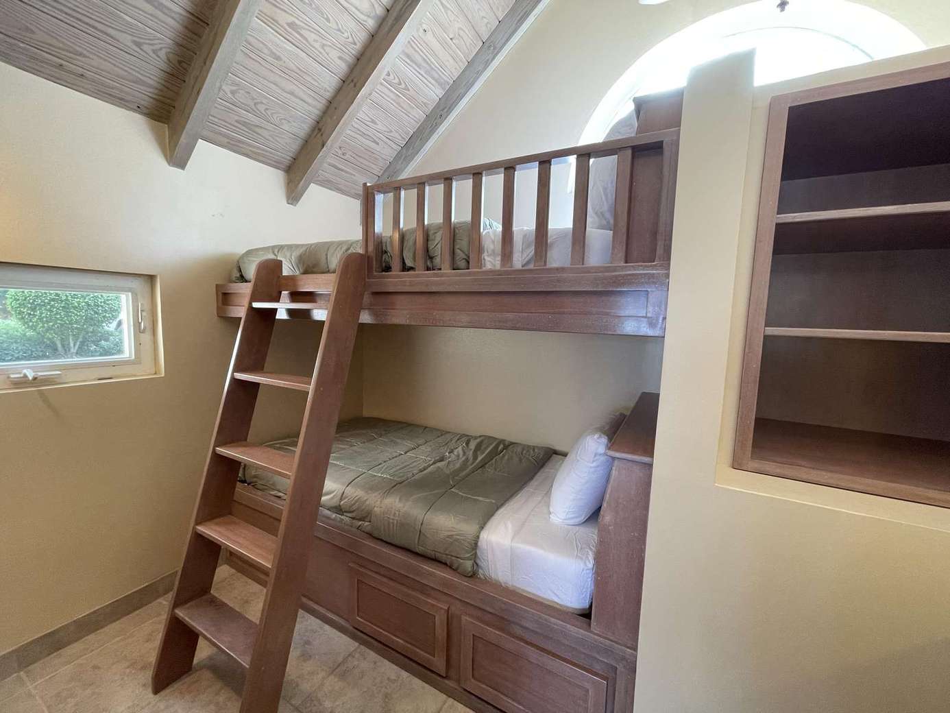 Cozy bunk bed nook with vaulted ceilings and natural light