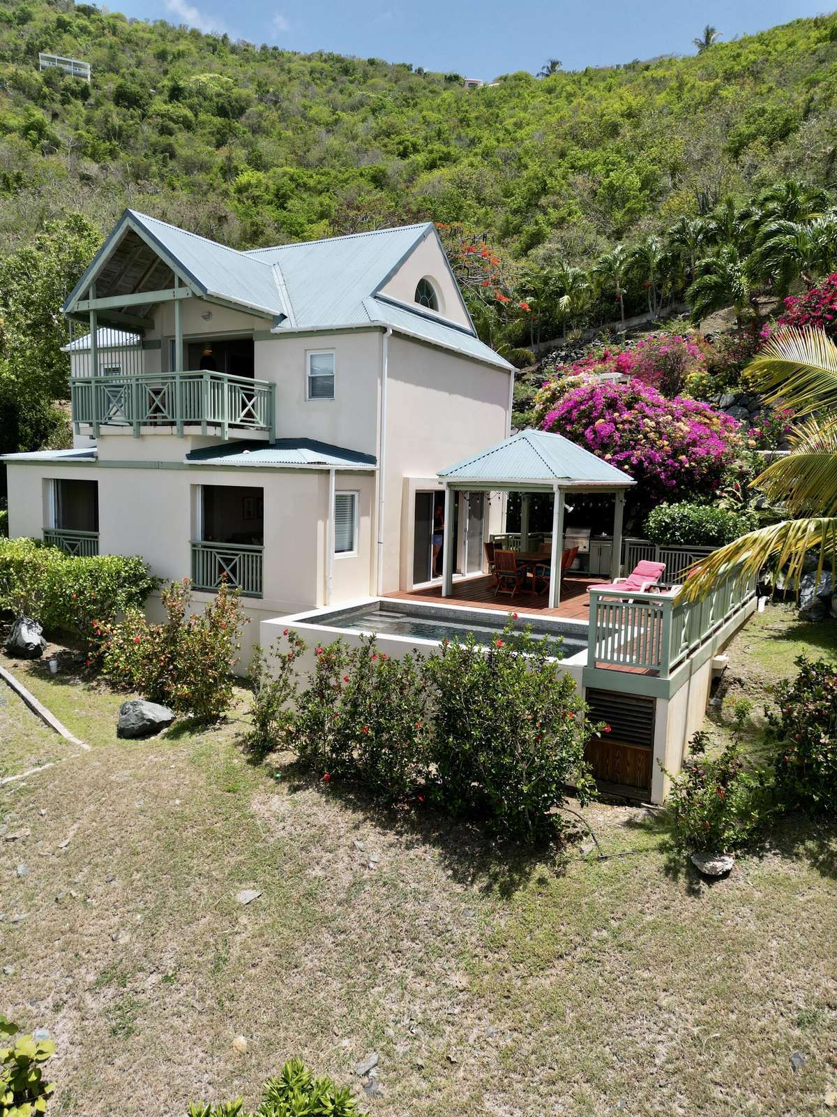 Charming hillside retreat with spacious outdoor patio and vibrant garden